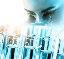 Researcher looking through a microscope