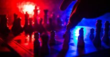 A chessboard with several chess pieces in motion