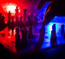 A chessboard with several chess pieces in motion