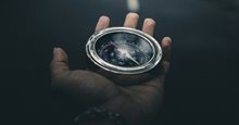 Man holding a navigation compass in hand (1)